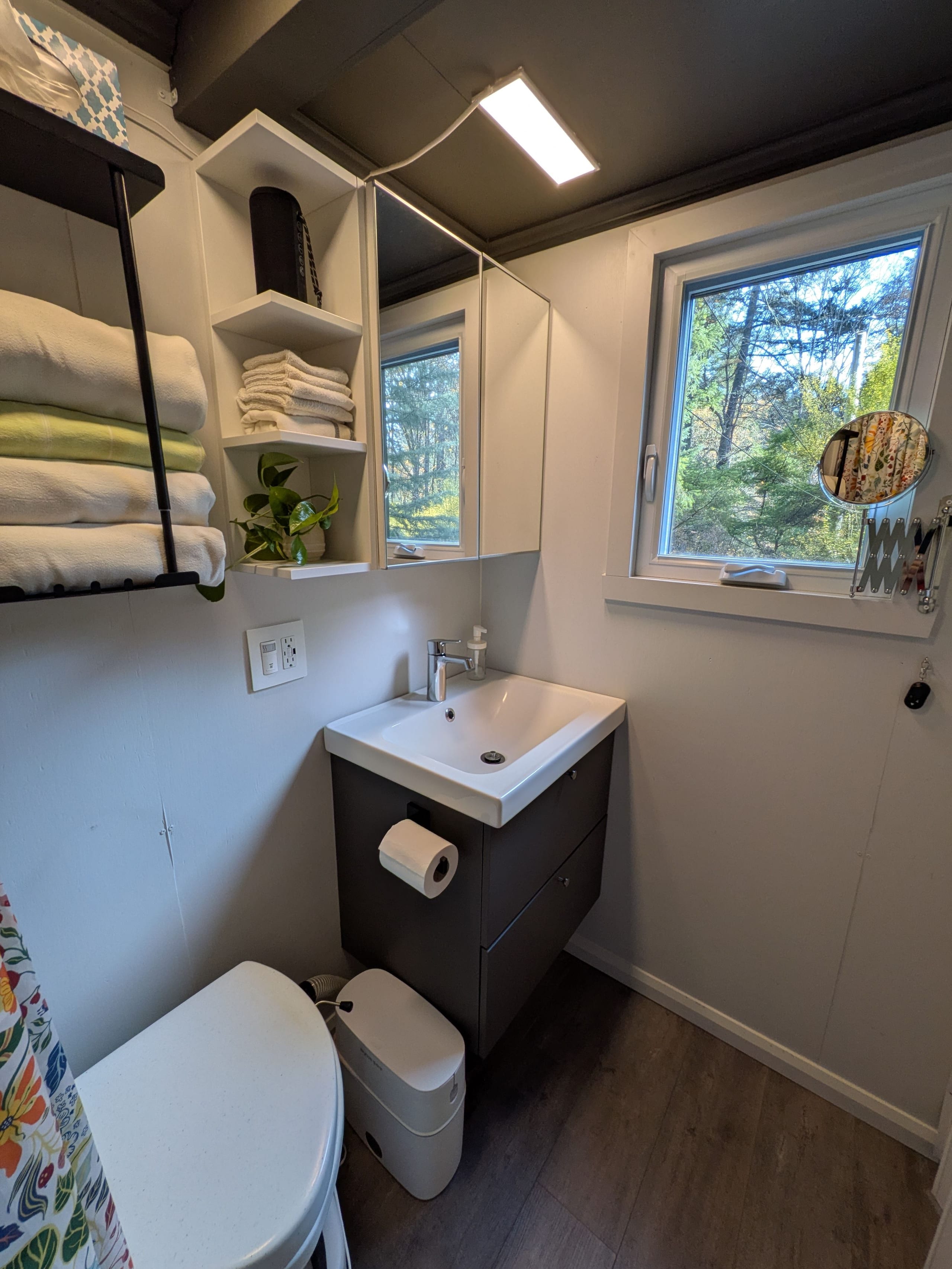 Bathroom vanity with sink, toilet and a window