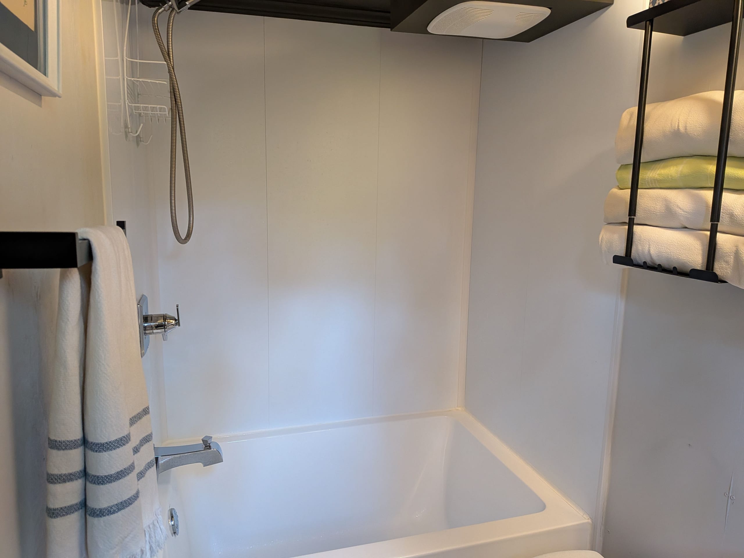 Shower with tiled surround and towels